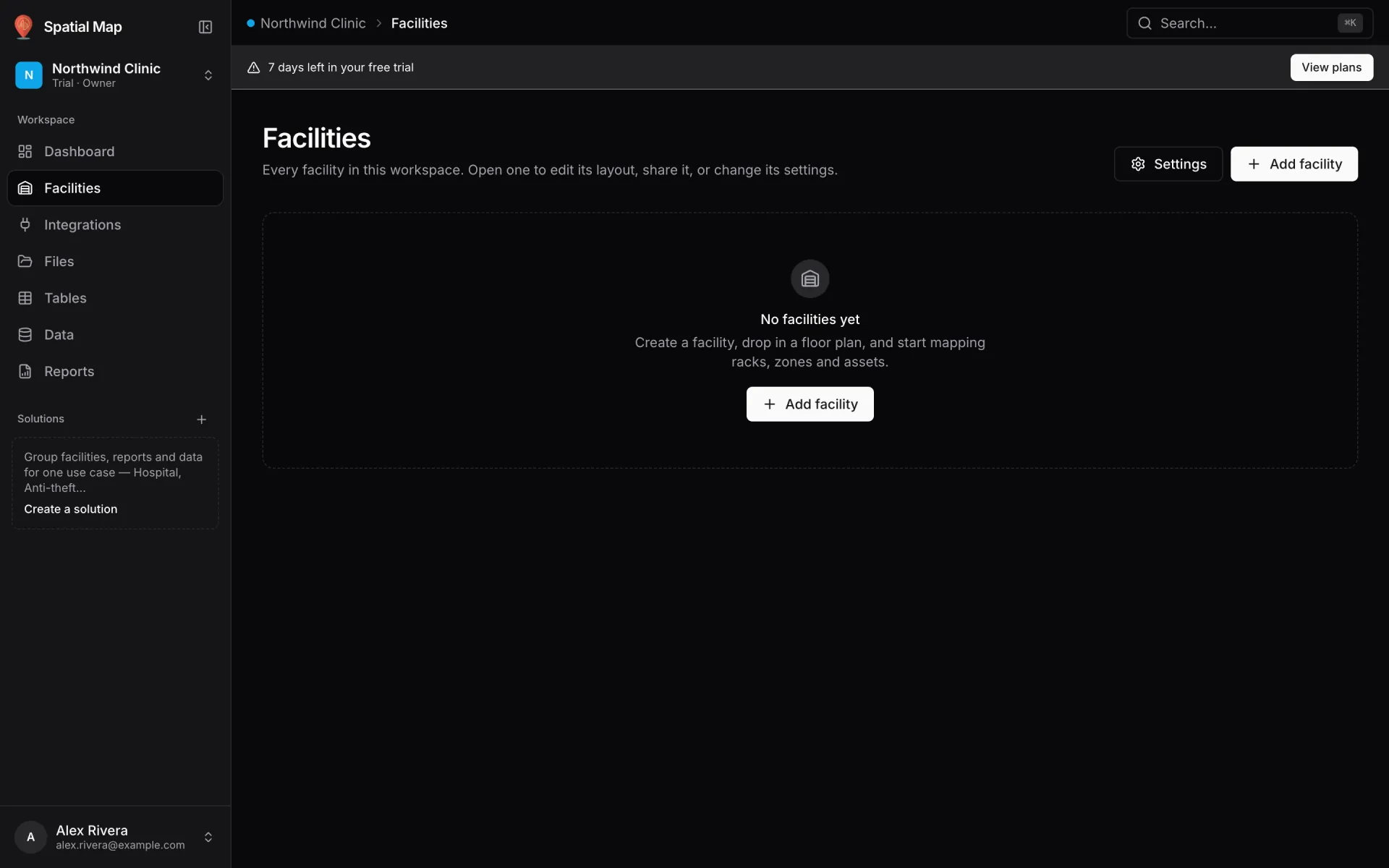 Empty Facilities screen in a new trial workspace with a 7 days left in your free trial banner, the No facilities yet message and an Add facility button